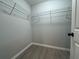 Walk in closet features wood-look flooring, metal shelving and neutral paint at 203 Locust Pass, Ocala, FL 34472