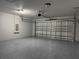 Spacious two car garage with epoxy flooring and a roll up door at 203 Locust Pass, Ocala, FL 34472