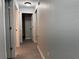 Hallway with wood floors, neutral paint, and doors leading to various rooms at 203 Locust Pass, Ocala, FL 34472