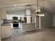Bright kitchen with stainless appliances, center island, and modern pendant lighting at 203 Locust Pass, Ocala, FL 34472