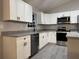Bright kitchen featuring stainless steel appliances, granite countertops, and ample cabinetry at 203 Locust Pass, Ocala, FL 34472