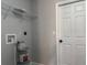 Laundry room with shelving and a utility sink at 203 Locust Pass, Ocala, FL 34472