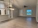 Spacious living room featuring wood-look floors, a front door, and a window at 203 Locust Pass, Ocala, FL 34472