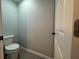 Powder room with toilet and door at 203 Locust Pass, Ocala, FL 34472