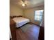 Bedroom featuring a ceiling fan, wood floors, and natural light at 2127 N.E. 40Th Ave., Ocala, FL 34470