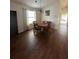 Cozy dining room featuring hardwood floors, a wooden table, and natural light from a nearby window at 2127 N.E. 40Th Ave., Ocala, FL 34470