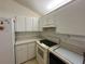Efficient kitchen with white appliances, white cabinets, and laminate countertops at 2127 N.E. 40Th Ave., Ocala, FL 34470
