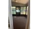 Enclosed sunroom featuring screened windows and a neutral carpet, ideal for relaxation and enjoying the outdoors at 2127 N.E. 40Th Ave., Ocala, FL 34470