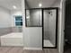 Modern bathroom featuring a soaking tub, separate shower with glass door, and stylish tile work at 227 Locust Rd, Ocala, FL 34472