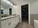 Bright Primary bathroom with double vanity featuring granite countertop, modern fixtures, and wood-look floors at 227 Locust Rd, Ocala, FL 34472