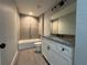 Updated bathroom featuring modern vanity and tiled tub/shower combo at 227 Locust Rd, Ocala, FL 34472