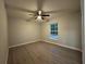 Bedroom featuring light colored walls, ceiling fan and luxury vinyl flooring at 227 Locust Rd, Ocala, FL 34472