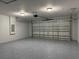 Spacious two-car garage featuring epoxy floors and plenty of overhead storage at 227 Locust Rd, Ocala, FL 34472