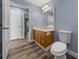 Bathroom with wood-look floors, vanity, mirror, and toilet at 2312 Sw 140Th Ct, Ocala, FL 34481