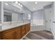 Bright bathroom featuring double vanity, soaking tub, and wood-look floors at 2312 Sw 140Th Ct, Ocala, FL 34481