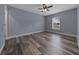 Bedroom with ceiling fan, window, and wood-look floors at 2312 Sw 140Th Ct, Ocala, FL 34481