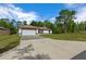 Well-maintained single-Gathering home with a spacious driveway and lush landscaping at 2312 Sw 140Th Ct, Ocala, FL 34481