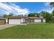 Charming one-story home with a well-maintained lawn and attached two-car garage at 2312 Sw 140Th Ct, Ocala, FL 34481