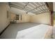 Open garage space with visible mechanics, utility sink and door to main house at 2312 Sw 140Th Ct, Ocala, FL 34481