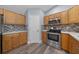 Bright kitchen with wooden cabinets, granite countertops, and stainless steel appliances at 2312 Sw 140Th Ct, Ocala, FL 34481