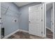 Charming laundry room features blue walls, faux wood floors, and a wire rack for easy storage at 2312 Sw 140Th Ct, Ocala, FL 34481