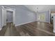 Open-concept living room with modern floors and access to laundry room and backyard at 2312 Sw 140Th Ct, Ocala, FL 34481