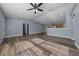 Spacious living room featuring hardwood floors, ceiling fan, and lots of natural light at 2312 Sw 140Th Ct, Ocala, FL 34481