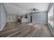 Open-concept living room with wood floors, ceiling fan, and abundant natural light at 2312 Sw 140Th Ct, Ocala, FL 34481