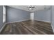 Bright main bedroom with ensuite bathroom, wood-look floors, and a ceiling fan at 2312 Sw 140Th Ct, Ocala, FL 34481
