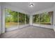 Relaxing screened porch offers tile flooring and views of a lush, wooded backyard at 2312 Sw 140Th Ct, Ocala, FL 34481