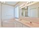 Primary bathroom featuring double sinks, vanity, a large soaking tub, and updated lighting at 2339 Nw 55Th Avenue Rd, Ocala, FL 34482