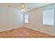 Spacious bedroom with hardwood floors, ceiling fan, and natural light from two windows at 2339 Nw 55Th Avenue Rd, Ocala, FL 34482