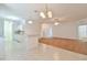 Bright dining area open to kitchen with chandelier, white cabinets, and breakfast bar for casual dining at 2339 Nw 55Th Avenue Rd, Ocala, FL 34482