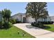 Charming single-story home with well-manicured landscaping and a spacious driveway leading to a two-car garage at 2339 Nw 55Th Avenue Rd, Ocala, FL 34482