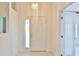 Inviting foyer with a decorative light fixture, tiled floor and a bright white front door with sidelight at 2339 Nw 55Th Avenue Rd, Ocala, FL 34482