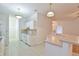 Functional kitchen with white cabinets, tiled floors, and a breakfast bar, perfect for everyday meals and gatherings at 2339 Nw 55Th Avenue Rd, Ocala, FL 34482