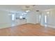 Open-concept living room with wood floors, adjacent to the kitchen with a breakfast bar, perfect for entertaining at 2339 Nw 55Th Avenue Rd, Ocala, FL 34482