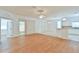 Open-concept living room featuring wood flooring, access to the kitchen, and sliding glass doors with ample natural light at 2339 Nw 55Th Avenue Rd, Ocala, FL 34482