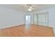 Bright living room features wood floors, fan, and sliding glass doors for natural light and easy outdoor access at 2339 Nw 55Th Avenue Rd, Ocala, FL 34482