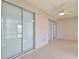 Enclosed patio with tiled floor, ceiling fan, and sliding glass doors, offering a versatile space at 2339 Nw 55Th Avenue Rd, Ocala, FL 34482