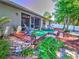 Inviting screened porch and landscaped backyard with stylish Adirondack chairs on a wooden deck and privacy fence at 2410 Se 23Rd Pl, Ocala, FL 34471