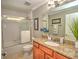 Granite-countered vanity and a glass-enclosed shower in a bright bathroom at 2410 Se 23Rd Pl, Ocala, FL 34471