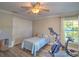 Bright bedroom featuring wood-look floors, closet, and a ceiling fan at 2410 Se 23Rd Pl, Ocala, FL 34471