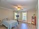 Cozy bedroom with two windows, a ceiling fan, and wood-look flooring, perfect for relaxation at 2410 Se 23Rd Pl, Ocala, FL 34471