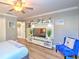 Tastefully decorated bedroom with a flat screen TV, ceiling fan and a sitting area at 2410 Se 23Rd Pl, Ocala, FL 34471