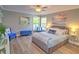 Bedroom features a bed, two windows, and modern nautical-themed decor at 2410 Se 23Rd Pl, Ocala, FL 34471