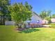Charming home exterior featuring well-manicured lawn, mature trees, and tasteful landscaping for curb appeal at 2410 Se 23Rd Pl, Ocala, FL 34471