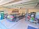 Spacious garage with car, storage solutions, bikes, and ample space for parking and hobbies at 2410 Se 23Rd Pl, Ocala, FL 34471