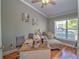 Comfortable home office with natural light, a writing desk, and a chaise lounge seating area for a relaxed work environment at 2410 Se 23Rd Pl, Ocala, FL 34471