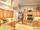 Modern kitchen with stainless steel appliances, granite countertops, custom cabinets, and tile flooring at 2410 Se 23Rd Pl, Ocala, FL 34471